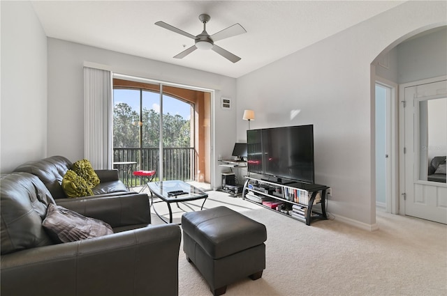 living room featuring light colored carpet and ceiling fan