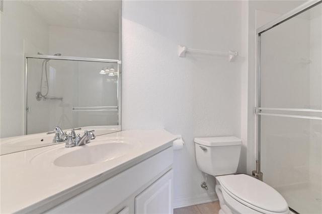 bathroom with walk in shower, toilet, large vanity, and tile flooring