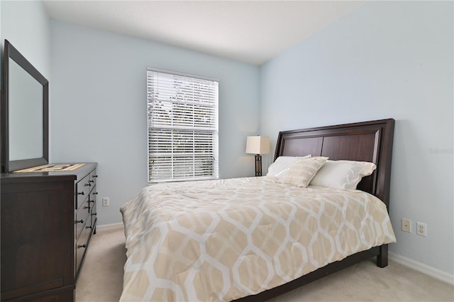 bedroom featuring light carpet