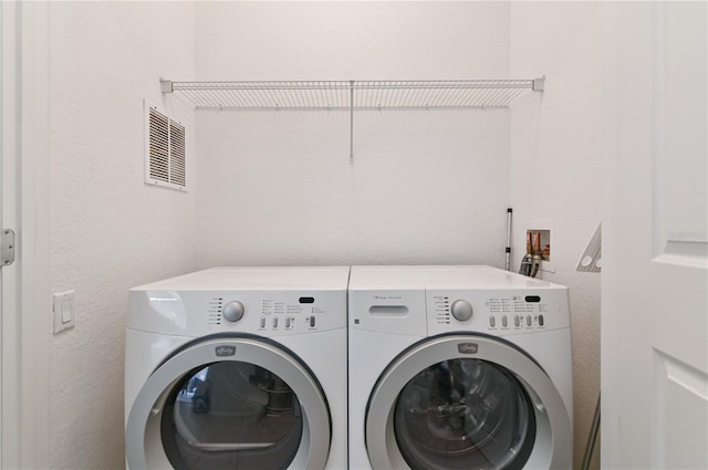 laundry room featuring hookup for a washing machine and washer and dryer