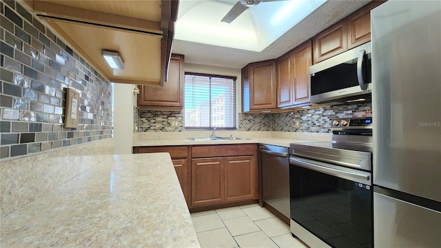 kitchen with light tile floors, ceiling fan, tasteful backsplash, appliances with stainless steel finishes, and sink