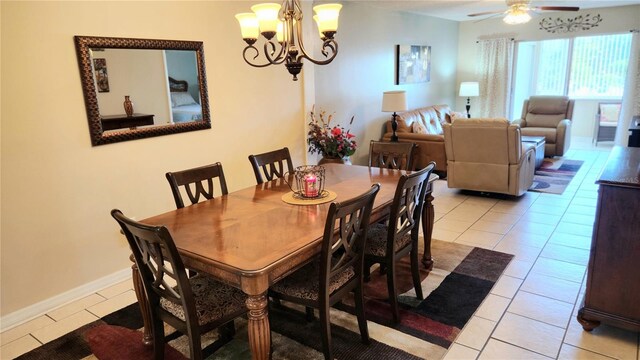 tiled dining area with ceiling fan with notable chandelier