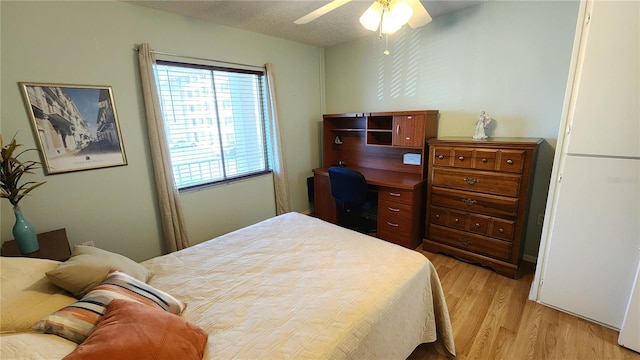 bedroom with light hardwood / wood-style floors and ceiling fan