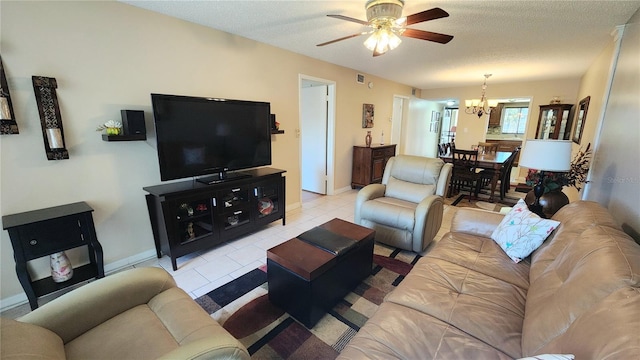 living room featuring light tile floors, a textured ceiling, and ceiling fan with notable chandelier