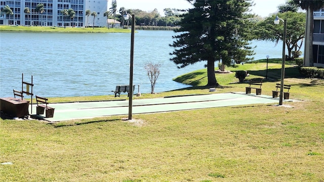 dock area with a water view and a lawn