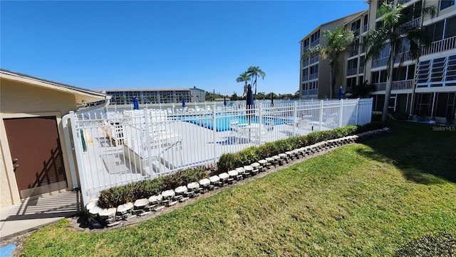 view of swimming pool with a yard