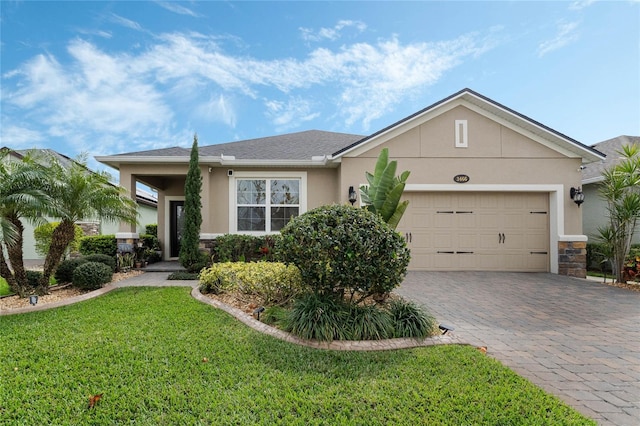 single story home featuring a front lawn and a garage