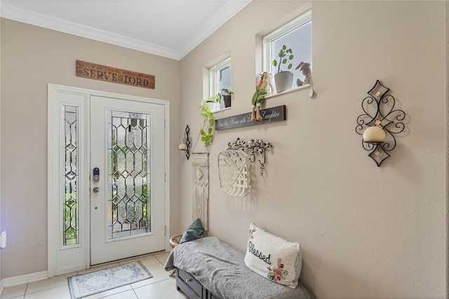 foyer with light tile patterned flooring and crown molding