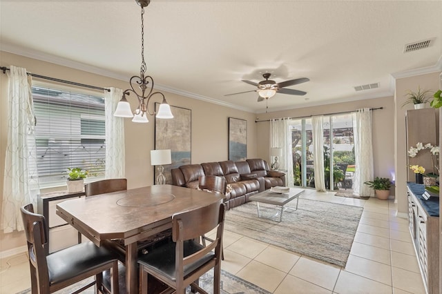 dining room featuring ceiling fan with notable chandelier, light tile patterned floors, and crown molding