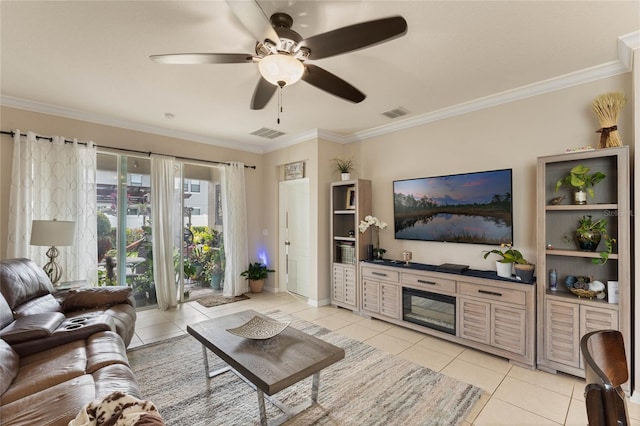 living room with ornamental molding, ceiling fan, and light tile patterned floors