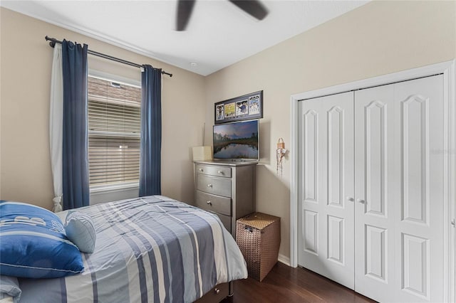 bedroom featuring dark wood-type flooring, ceiling fan, and a closet