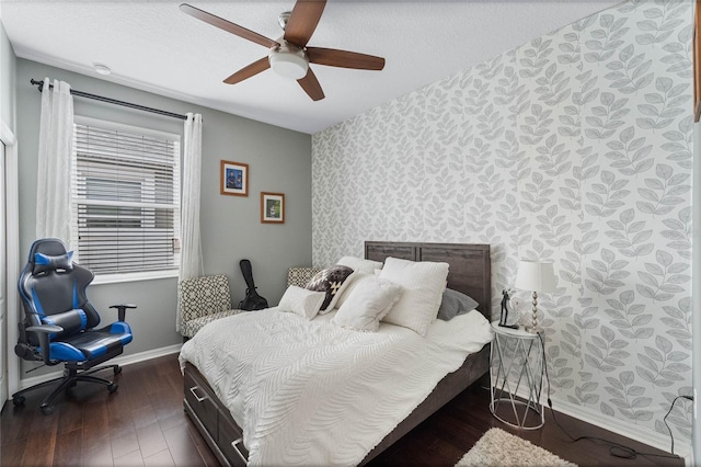 bedroom featuring a textured ceiling, dark hardwood / wood-style flooring, and ceiling fan