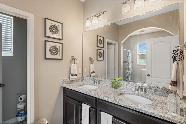 bathroom with walk in shower and vanity