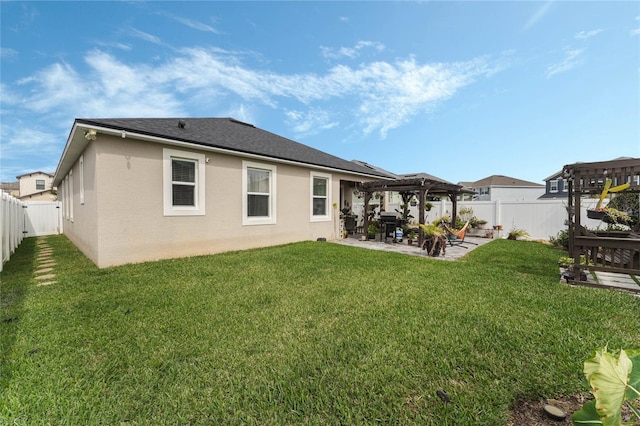 back of property featuring a yard, a pergola, and a patio area