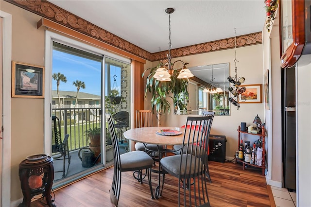 dining space featuring plenty of natural light, a chandelier, and dark hardwood / wood-style flooring