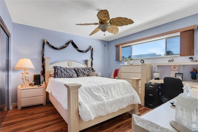 bedroom with a closet, dark hardwood / wood-style floors, and ceiling fan