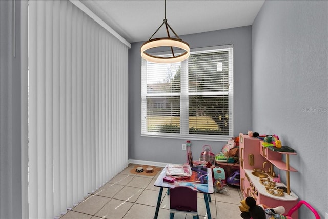 rec room with light tile flooring and plenty of natural light