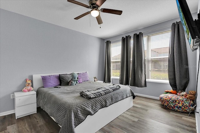 bedroom with ceiling fan and light hardwood / wood-style flooring