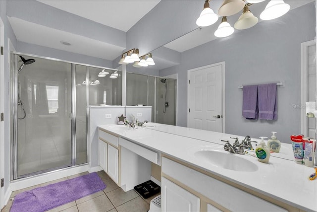 bathroom with a chandelier, an enclosed shower, double sink vanity, and tile flooring