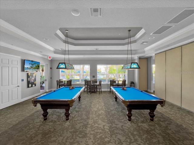 rec room with pool table, a tray ceiling, and dark colored carpet