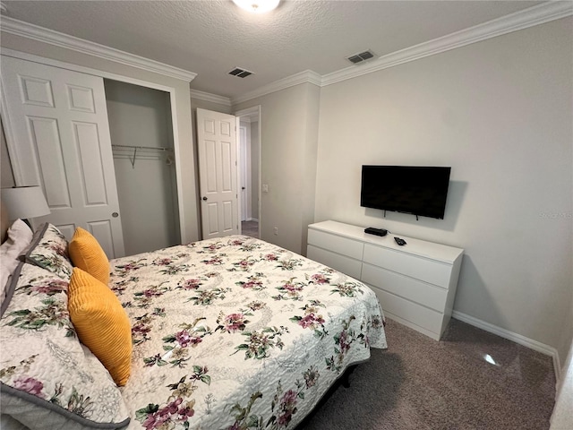 bedroom with ornamental molding, carpet flooring, a closet, and a textured ceiling