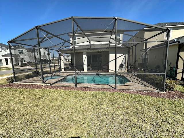 view of swimming pool featuring a lanai and a lawn