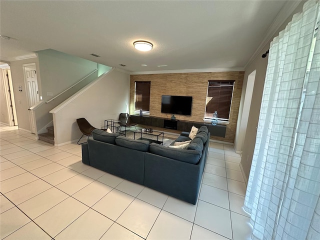 living room with ornamental molding and light tile flooring