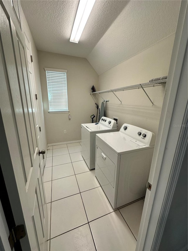 laundry area featuring independent washer and dryer, washer hookup, a textured ceiling, and light tile flooring