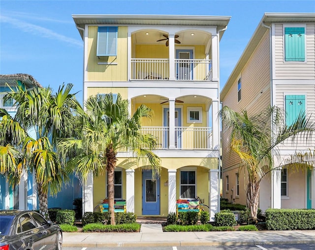 raised beach house with ceiling fan and a balcony