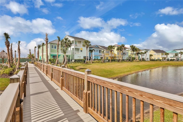 view of home's community featuring a water view and a yard