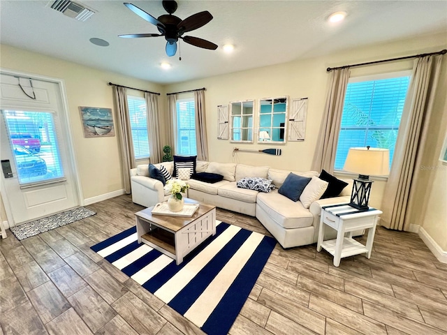 living room featuring light wood-type flooring and ceiling fan