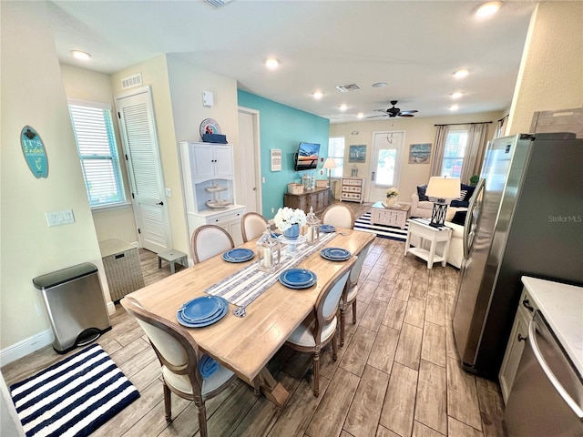 dining area with ceiling fan and light hardwood / wood-style flooring