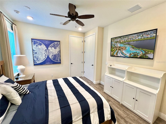 bedroom featuring light wood-type flooring and ceiling fan