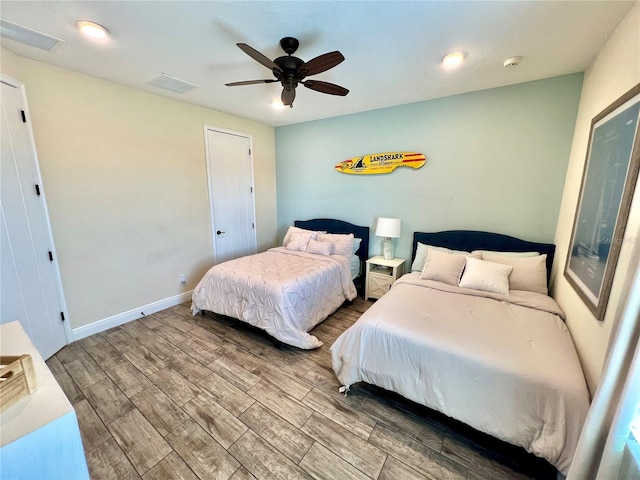 bedroom featuring hardwood / wood-style floors and ceiling fan