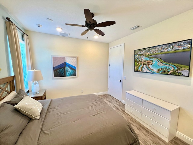 bedroom with light wood-type flooring and ceiling fan