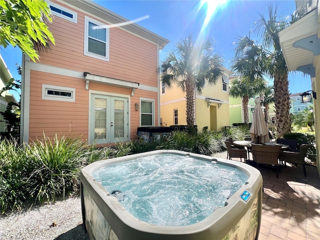 view of pool featuring a hot tub and french doors