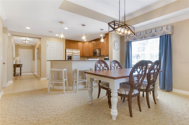 dining room featuring a chandelier, light tile flooring, and ornamental molding