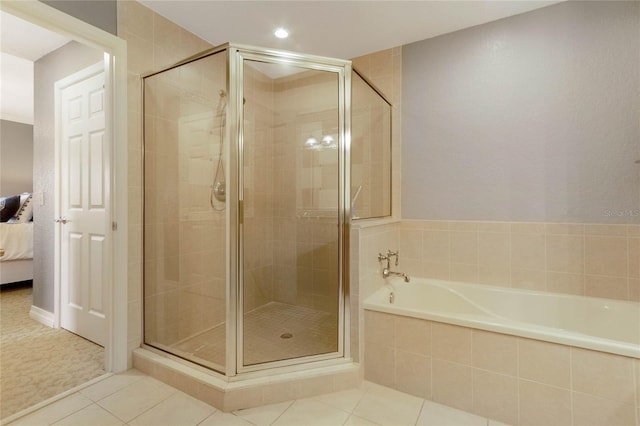 bathroom with separate shower and tub and tile flooring