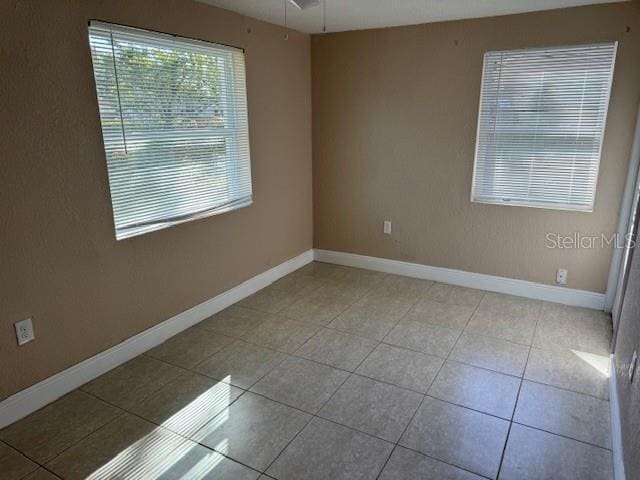 unfurnished room featuring light tile floors