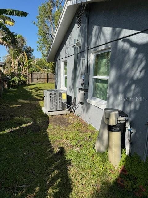 view of home's exterior with a yard and central air condition unit