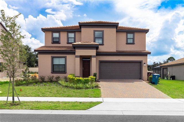 mediterranean / spanish-style house with a front yard and a garage