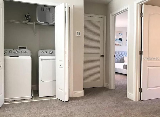 washroom featuring light colored carpet and washing machine and clothes dryer