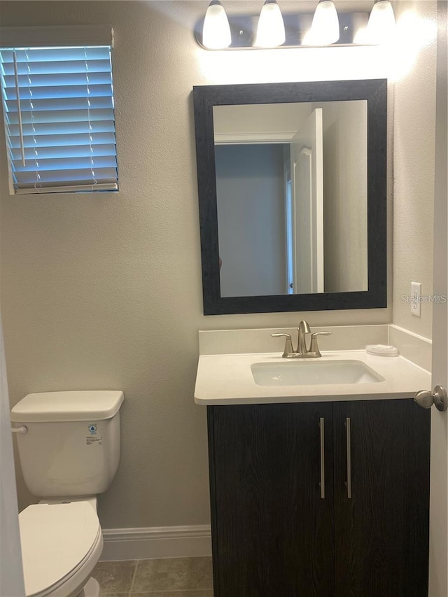 bathroom with tile patterned floors, vanity, and toilet