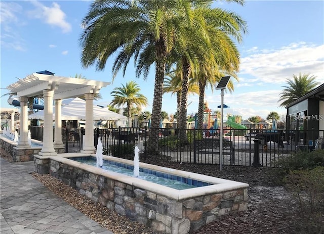 view of swimming pool featuring a playground