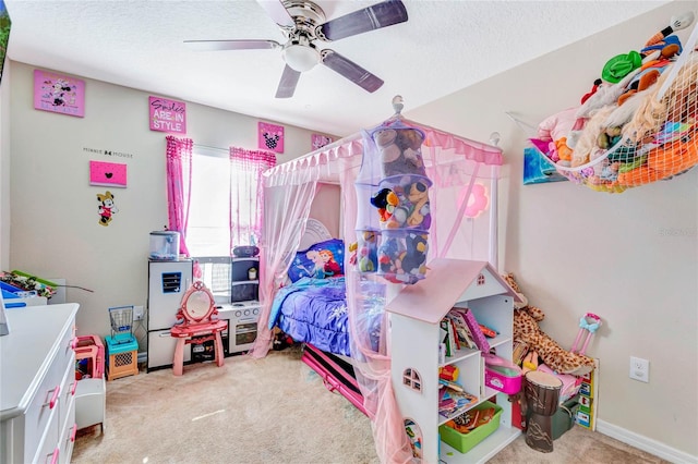 carpeted bedroom with ceiling fan and a textured ceiling