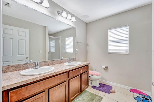 bathroom featuring double sink, tile floors, large vanity, and toilet