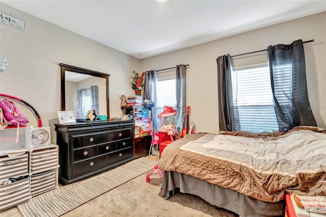 carpeted bedroom with multiple windows