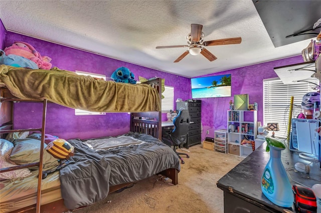 carpeted bedroom with a textured ceiling and ceiling fan