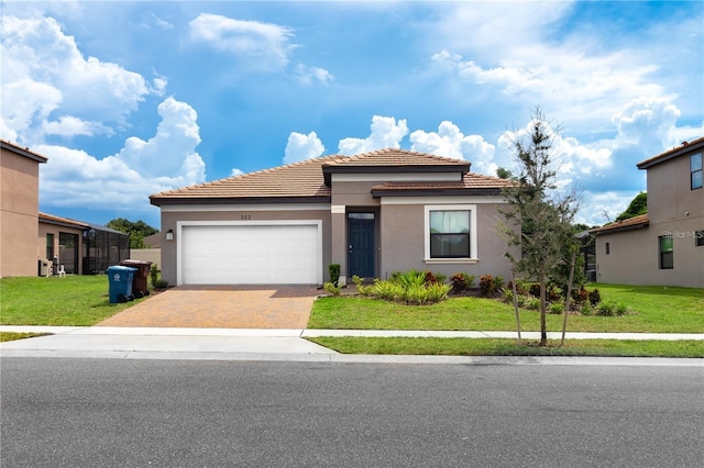 view of front of home with a front yard and a garage