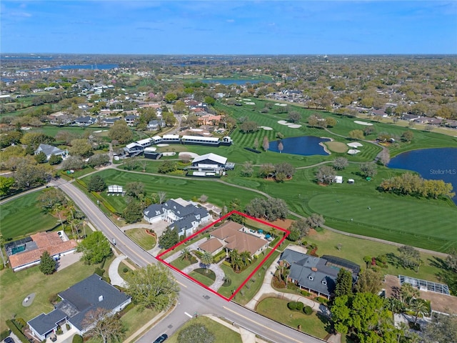 bird's eye view with golf course view, a water view, and a residential view